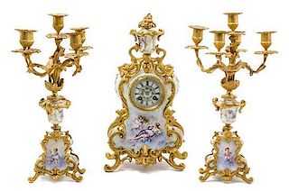 * A Louis XV Style Gilt Bronze and Sevres Style Porcelain Clock Garniture Height of candelabra 16 3/4 inches.