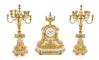 A Napoleon III Gilt Bronze and Onyx Clock Garniture Height of candelabra 30 1/2 inches.