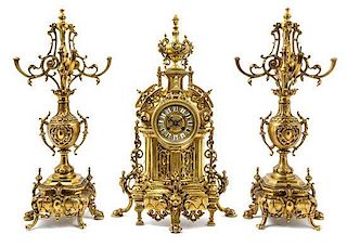 A French Gilt Brass Clock Garniture Height of clock 22 1/2 inches.