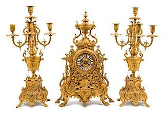 * A Neoclassical Style Gilt Bronze Clock Garniture Height of candelabra 22 inches.