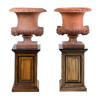 * A Pair of Terra Cotta Urns on Stands Height 27 1/2 inches.