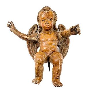 * A Carved and Painted Wood Figure of a Cherub Height 18 inches.