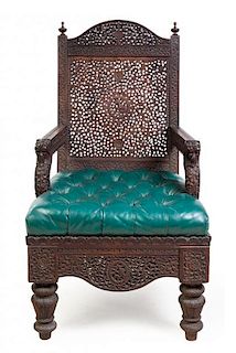 An Anglo-Indian Carved Armchair Height 38 7/8 inches.