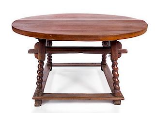 * An English Baroque Oak Table Height 30 1/2 x diameter 52 1/2 inches.