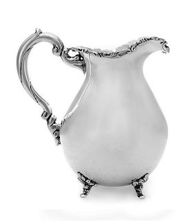 * A Silver Water Pitcher, Maker's Mark JDB, having a baluster form body with an S-scroll and foliate decorated rim, raised on
