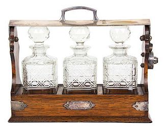 An English Silver Plate Mounted Oak Tantalus Height 11 1/4 x length 13 3/4 inches.