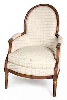 A Louis XVI Carved Walnut Bergere Height 37 inches.