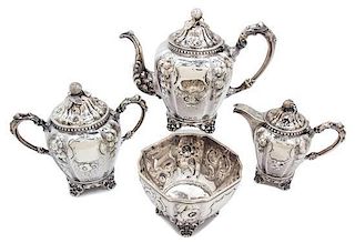 An American Coin Silver Tea Set, Wood & Hughes, New York, comprising a teapot, creamer, covered sugar, and waste bowl.