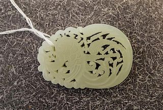 A Celadon Jade Pendant. Length 2 1/4 inches.