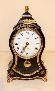 A Gilt Decorated Ebonized Mantel Clock. Height 12 1/2 inches.