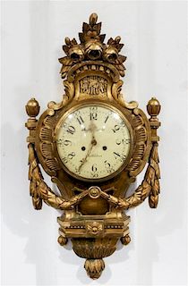 A Swedish Giltwood Cartel Clock. Height 28 x width 14 inches.