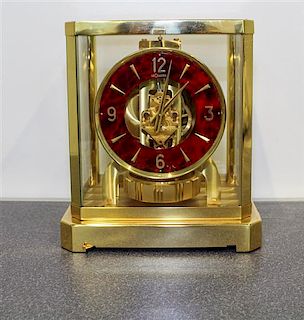 A Swiss Brass Atmos Clock. Height 9 3/4 inches.