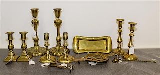 * A Collection of Four Pairs of Brass Candlesticks Height of tallest pair 10 1/4 inches.
