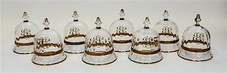 A Set of Eight Gilt Decorated Glass Cloches Height 5 inches.