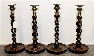 * A Set of Four Twisted Wood Candlesticks. Height 12 1/2 inches.