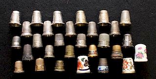 A Collection of Porcelain and Silver Thimbles Average height 1 inches.