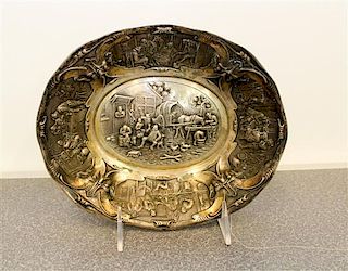 A Dutch Silver Bowl, 1854, of oval form, the border decorated with grotesque masks flanking cartouches depicting tavern scene