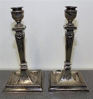 A Pair of Silver-Plate Candlesticks Height 9 3/8 inches.