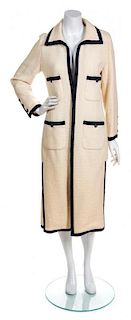 * A Chanel Cream Boucle Coat with Navy Trim, Size 38.