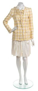 * A Chanel Yellow and Cream Boucle Skirt Suit, Jacket Size 36; Skirt Size 38.