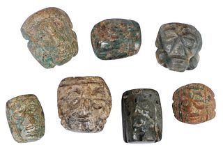 Seven Mesoamerican Carved Jade Mask Pendants