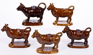 AMERICAN ROCKINGHAM-GLAZED POTTERY FIGURAL COW CREAMERS, LOT OF FIVE
