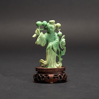 A CARVED GREEN JADE FIGURE WITH BASE  
