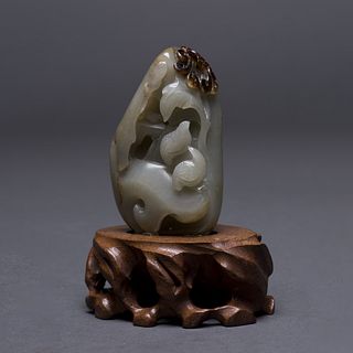 A CARVED JADE ORNAMENT WITH STAND 
