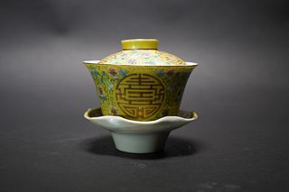 A CHINESE YELLOW GOUND 'SHOU' TEA CUP WITH LID AND STAND, FOUR-CHARACTER MARK