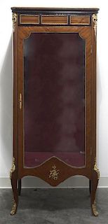A Louis XVI Style Gilt Metal Mounted Mahogany Vitrine, Height 64 1/2 x width 27 1/4 x depth 16 1/2 inches.