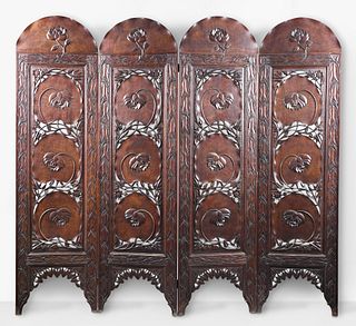 A very decorative early 20th century carved hardwood four part folding screen