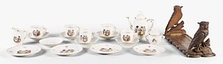 A child's porcelain tea set with images of anthropomorphic cats and owl bookends