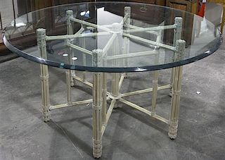 A Faux Bamboo and Glass Table. Height 28 1/2 inches x diameter 60 inches.