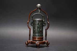 A CHINESE BRONZE BELL HOOKED WITH A WOODEN STAND