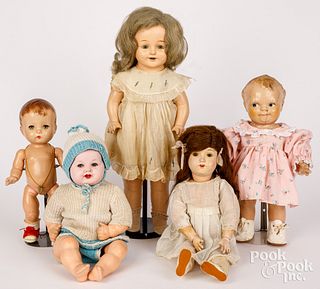 Five plastic and composition dolls