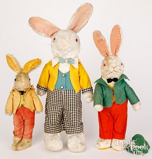 Three plush dressed rabbits