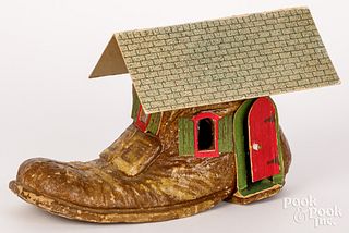 Papier-mâché old woman in shoe dollhouse