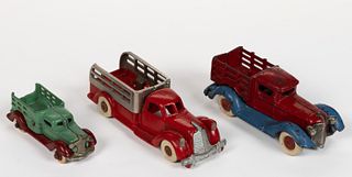 ASSORTED MANUFACTURERS CAST-IRON STAKE BED TOY TRUCKS, LOT OF THREE