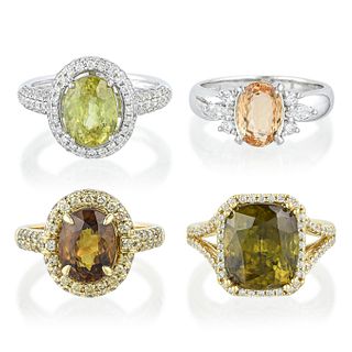 Three Sphene and Diamond Rings and a Topaz and Diamond Ring