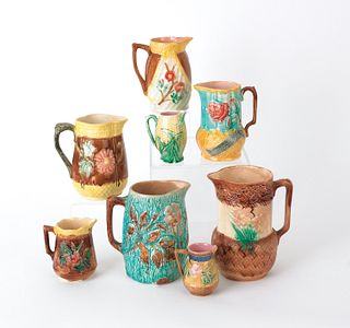 Eight majolica pitchers, tallest 8" h.