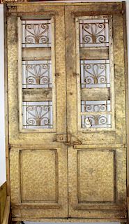 Pair weathered & carved entry doors with iron panels