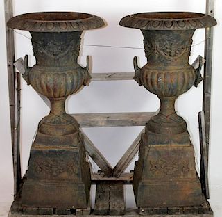 Pair of cast iron double handled garden urns