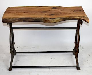 Industrial iron base table with naturalistic top