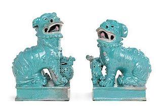 A Pair of Robin's Egg Glazed Porcelain Figures of Fu Lions Height of taller 10 1/4 inches.
