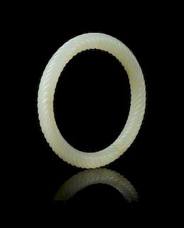 A Carved Celadon Jade Spiral Twist Bangle Diameter 3 inches.