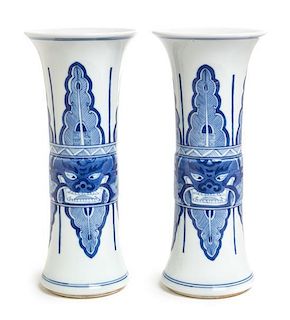 A Pair of Blue and White Porcelain Gu Vases Height of each 9 inches.