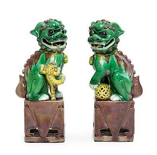A Pair of Sancai Glazed Porcelain Figure of Fu Lions Height of each 11 3/4 inches.