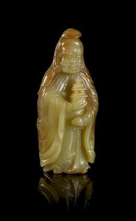 A Carved Yellow Jade Figure of a Guardian Height 4 3/4 inches.
