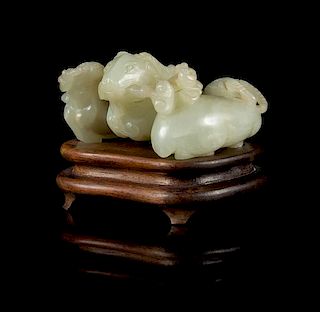 A Carved Celadon Jade Figure of Three Rams Length 2 3/4 inches.
