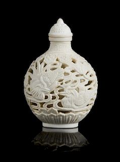 A White Carved Porcelain Snuff Bottle Height 2 3/4 inches.